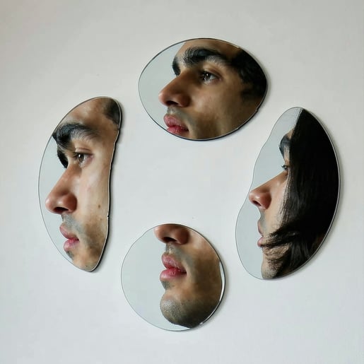 A series of mirrors meticulously positioned to form a circular arrangement each captures and reflects distinct features of a male single persons faceone mirror showcasing the gentle curve of the cheek another highlighting the arch of an eyebrow while